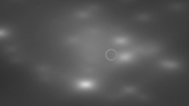 Circular UFO hovering in the night sky with blurry lights