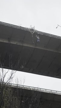 Bungee Jumper leaping from a Bridge in the Miguel Hidalgo suburb of Mexico City full jump and cries of the crowd as they watch