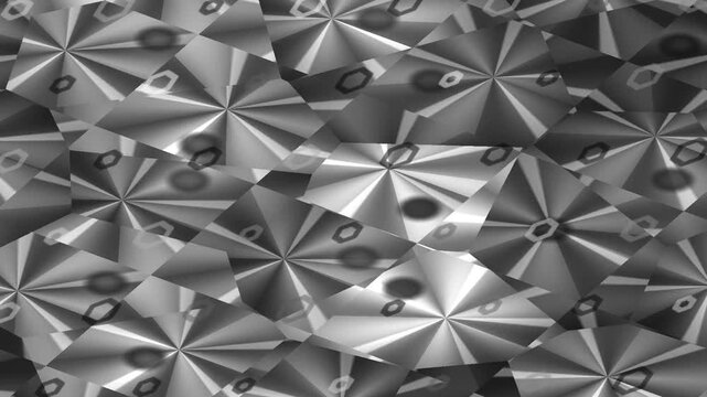 Close up of a metallic structure with pyramidal shapes and holes arranged in a dense pattern