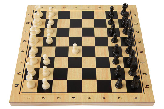 Wooden chessboard with plastic chess pieces initial e4 pawn move isolated on white background