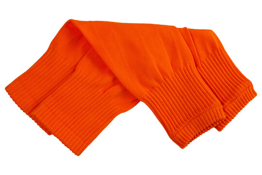 Pair of folded bright orange football leg sleeves isolated on white background