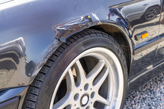 Close-Up of Damaged German Car Fender with Rust and electric tape quick fix.