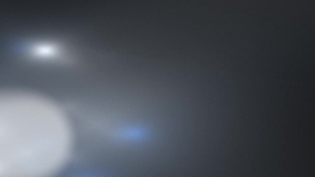 Blurred light flares and bokeh in a dark grayscale setting