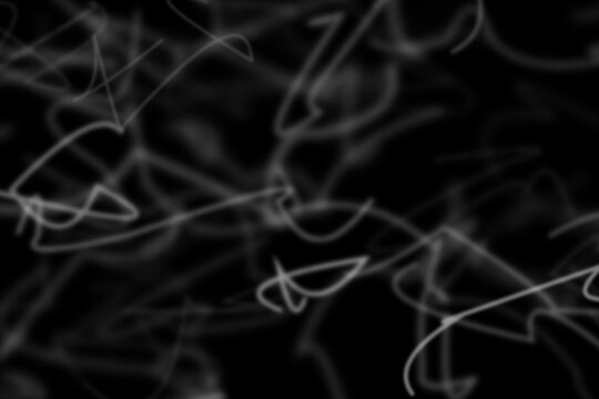 Abstract background, with white glowing, scribbled lines and, tangled light trails, on black
