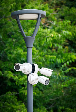 A complex of outdoor surveillance camera on a pole in the park. A complex of outdoor surveillance camera on a pole in the park. CCTV camera on a pole in the park. camera on a pole.