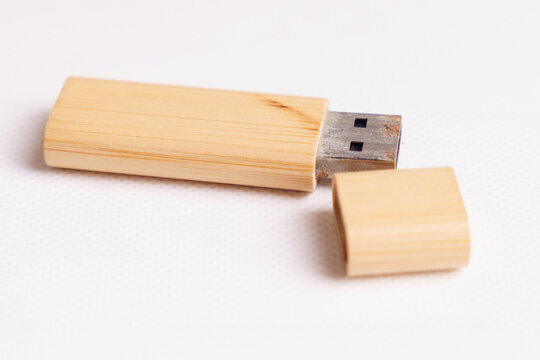 An aged bamboo USB flash drive with a visibly rusted USB connector, illustrating product longevity, aging technology, wear and tear, and continued functionality after years of use