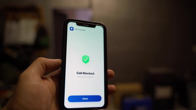 Incoming call from unknown number with spam warning on smartphone. Call blocker app blocking suspected spam call close-up