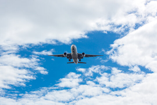 Airplane and sky, the plane is landing. Airplane take off on the blue sky, Aircraft flying on sky background. Passenger plane ready for landing. Low angle view of Airplane flying under blue sky