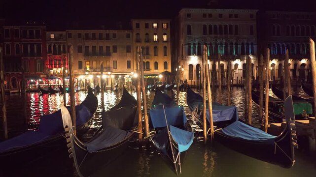 Venice canals, buildings and gondolas by night
