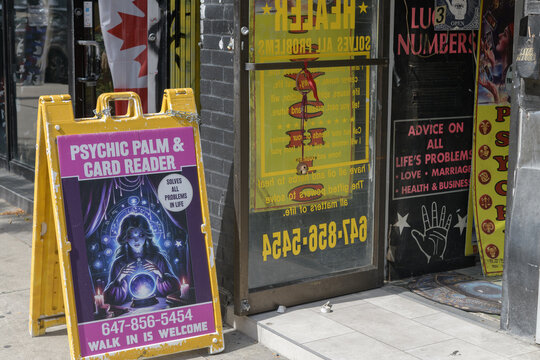 sidewalk a-frame poster sign outside 416 Queen St W for a Psychic in Toronto