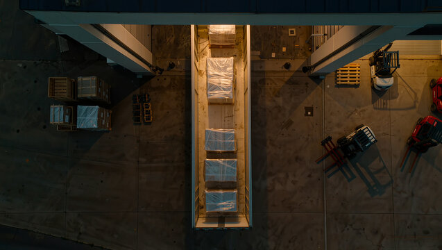 Aerial view of palletized cargo being loaded in warehouse bay