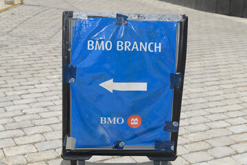 Obraz premium opulently derelict BMO Branch sign with directions to the one at Yonge & Harbour, Toronto