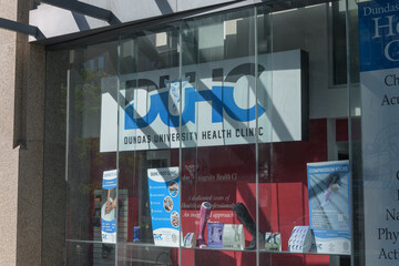 Obraz premium signage inside window at Dundas University Health Clinic, a chiropractor, located at 438 University Av, Toronto