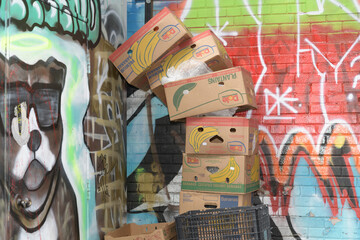 Fototapeta premium discarded cardboard Dole banana boxes in Graffiti Alley, Toronto