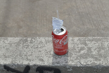 Fototapeta premium discarded wipes wrapper and can of Coca-Cola in Toronto