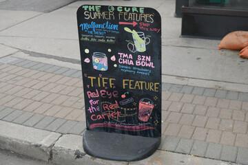 Obraz premium sidewalk black marker board of The Cure by TMA, a health food restaurant, located at 19 Mercer St, Toronto