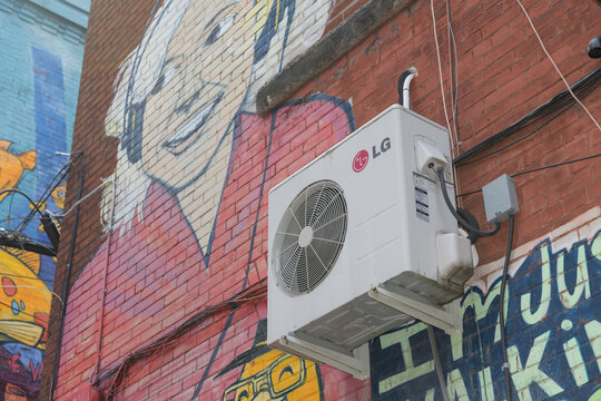 LG AC unit mounted to a wall with air-inlet/return grille or discharge grille and mural in Toronto