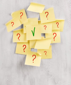 Yellow sticky notes show red question marks and one green check mark
