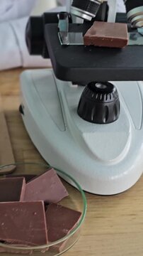 Exploring chocolate samples under the microscope in a laboratory