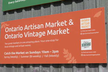 Obraz premium corrugated metal siding with sign of Ontario Artisan Market & Ontario Vintage Market at Evergreen Brick Works, 555 Bayview Av, Toronto