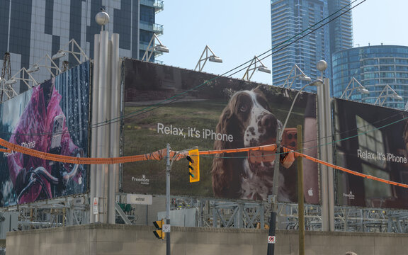 Apple Inc advertising banners at the southwest corner of Wellington St W and John St, Toronto ("Relax, it's iPhone")