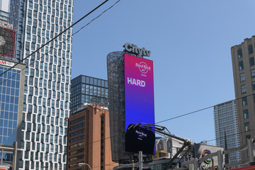 Obraz premium digital spectacular on the Citytv tower with advertising for Hard Rock Bet (an online gambling platform) facing Sankofa Square, Toronto 
