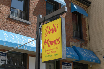 Obraz premium sign outside Delhi Momos and Indian Nepalese style restaurant, located at 113 Bond St, Toronto