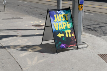 Obraz premium sidewalk a-frame poster sign outside Just Vape It located at 103 Mutual St (seen here on Dundas St E), Toronto