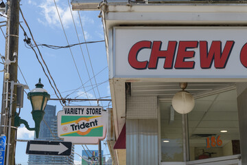 Obraz premium Chew Chew Grill sign and ghost Trident gum blade sign outside a variety store known as J&S Convenience, 184 Carlton St, Toronto