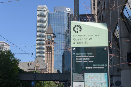 defocused TO360 totem or infopillar Financial District, Queen St W & York St, looking west to focused clocktower at Old City Hall, Toronto
