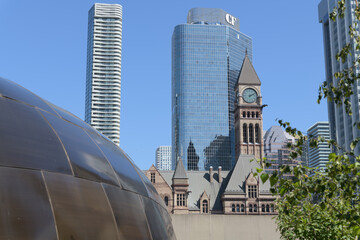 Obraz premium contrast of the Teaching Lodge at the Spirit Garden contrast with Massey Tower condos, Cadillac Fairview business tower, and clock tower of Old City Hall, Toronto