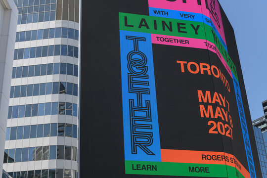 concert promotion for Harry Styles: Together, Together, featuring Lainey Wilson displayed on a digital spectacular at Sankofa Square, Toronto