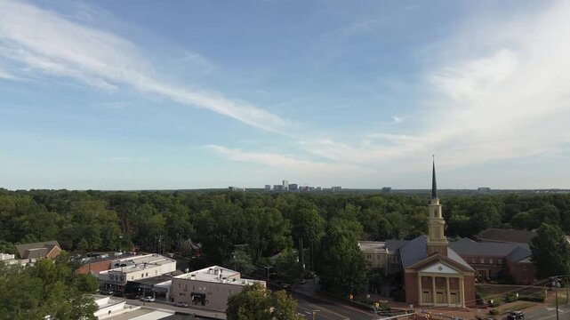 Aerial flyover shot of the Hayes Barton Five Points neighborhood of Raleigh, NC with North Hills in the distance