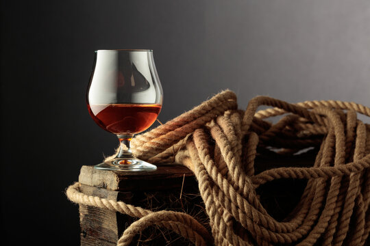 Glass of whiskey on a rough wooden crate.