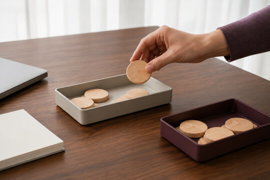 Hands Redistributing Wooden Budget Pieces for Financial Planning, Rebalancing and Resource Allocation