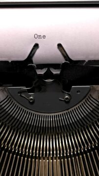 Vertical Macro Shot of Vintage Typewriter Typing the Word One