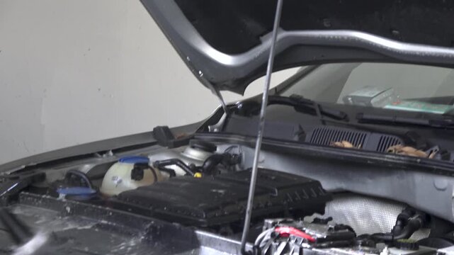 Auto Body Repair: Spray Painting Inside a Car Hood in a Workshop