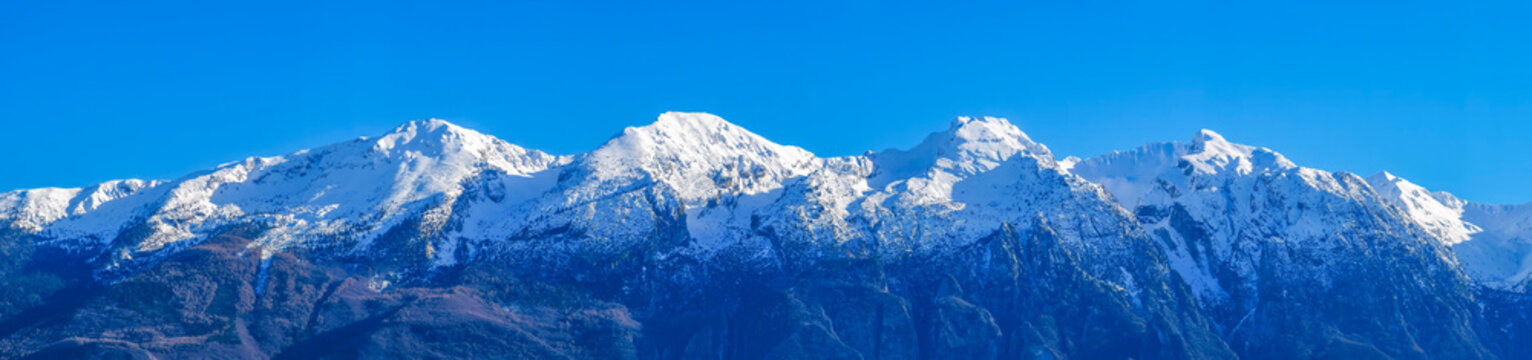 Panoramic view of the snow-capped peaks of the Monte Baldo range on Lake Garda. The third peak from the left is the highest peak, Cima Valdritta (2,218 m).