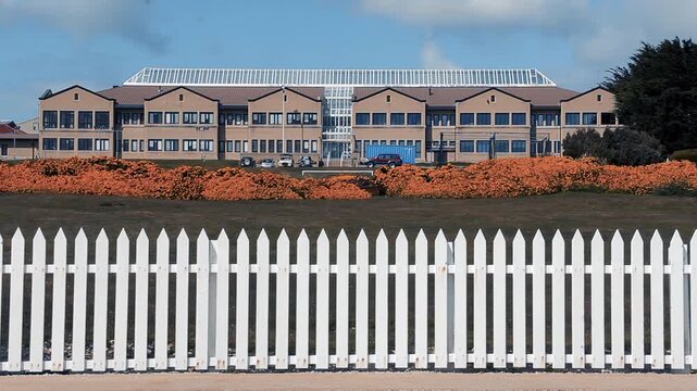 School Building View Behind Wooden Fence In Stanley Falklands (Malvinas) - 4K