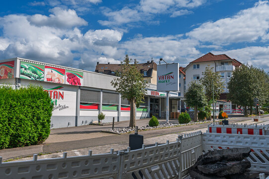 Iserlohn, Germany - August 23, 2026: Exterior of a Vatan Markt supermarket building next to road construction barriers under a blue sky