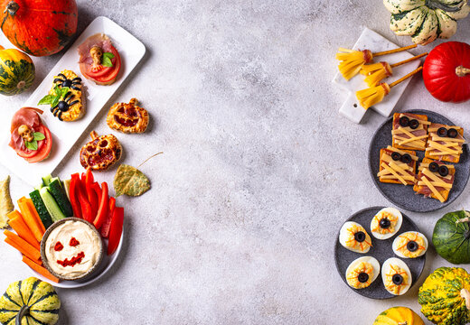 Halloween appetizers with pumpkin hummus deviled eggs and mummy snacks