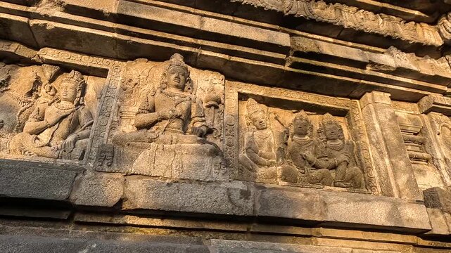 Ancient Stone Relief of Seated Deities at Borobudur Temple, Central Java, Indonesia