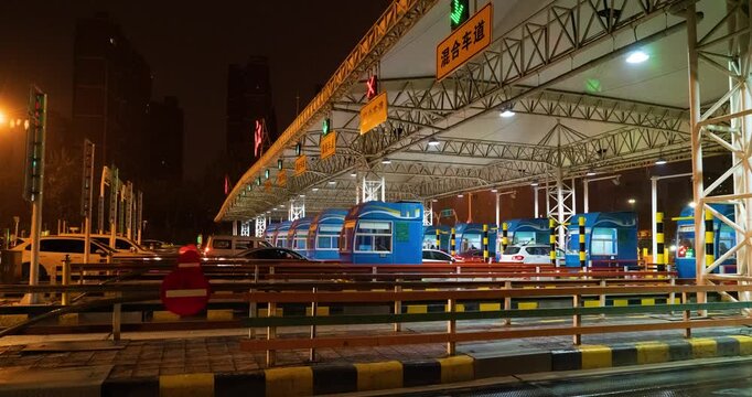 Truck passing through automated toll station gate at night in the city