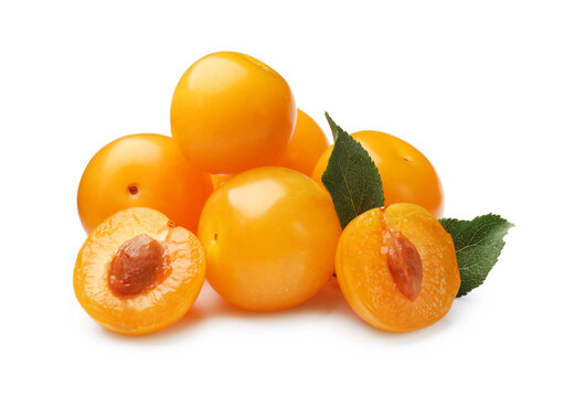 Yellow cherry plums with green leaves isolated on white