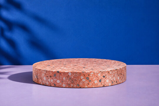 Coral terrazzo display pedestal on lavender and cobalt background