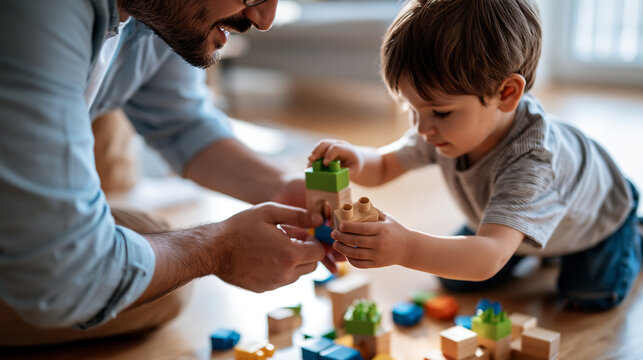 Top down view of man and boy playing with colorful building blocks on floor bright clean living room soft natural light aerial angle showing hands cheerful bonding activity cozy modern