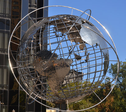NEW YORK CITY USA: Columbus Circle - Globe Sculpture this sparkling sculpture is at least 30 feet wide and is held above the ground by one big, chrome column. 