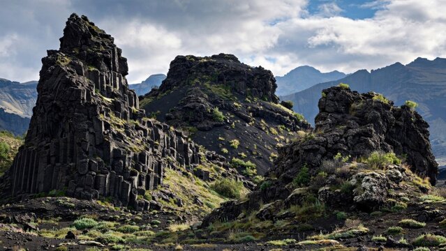Jagged volcanic rock formations rising from a rugged mountain