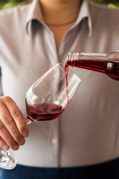 Waiter pouring a glass of Raspberry liqour.