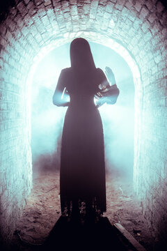 Silhouette of a woman in a brick tunnel
